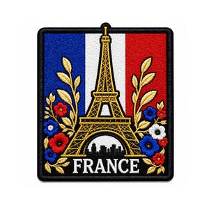May include: A rectangular embroidered patch featuring the French flag in blue, white, and red vertical stripes. A gold Eiffel Tower sits in the center, flanked by gold leaves and small red, white, and blue flowers. The word FRANCE is in white text.