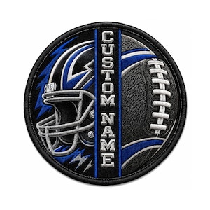 May include: A circular embroidered patch featuring a football helmet on the left and a football on the right, separated by a vertical blue stripe with the text CUSTOM NAME in silver block letters, all bordered by a thick black stitched edge.