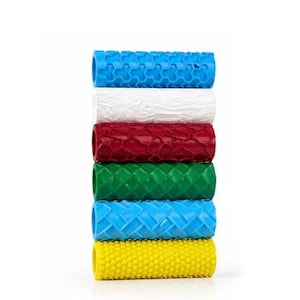 May include: A stack of six cylindrical patterned rollers in various colors including blue, white, red, green, light blue, and yellow. Each roller features a distinct embossed texture on its surface, designed for creating patterns on clay or dough.