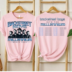 May include: A light pink t-shirt featuring a graphic of the Backstreet Boys with the text Backstreet Boys Millennium World Tour on the front and a list of tour dates and locations including D&uuml;sseldorf and Las Vegas printed on the back.