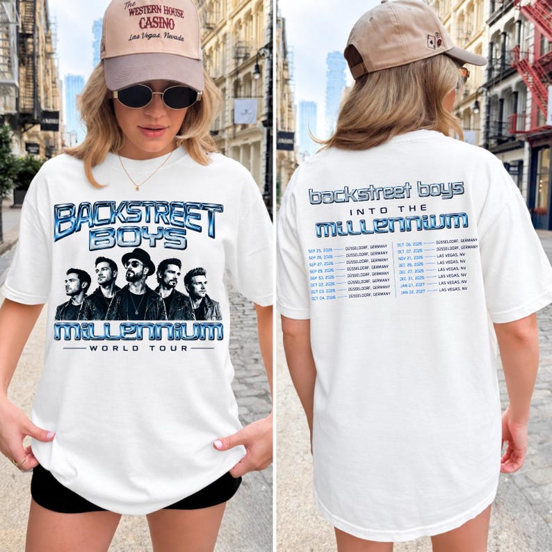 May include: A white t-shirt featuring a graphic print of the Backstreet Boys on the front with the text 'Backstreet Boys Millennium World Tour'. The back of the shirt displays the text 'Backstreet Boys Into The Millennium' and a list of tour dates.