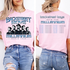May include: A light pink t-shirt featuring a graphic of the Backstreet Boys with the text Backstreet Boys Into The Millennium World Tour on the front and a list of tour dates and locations in Dusseldorf and Las Vegas printed on the back.