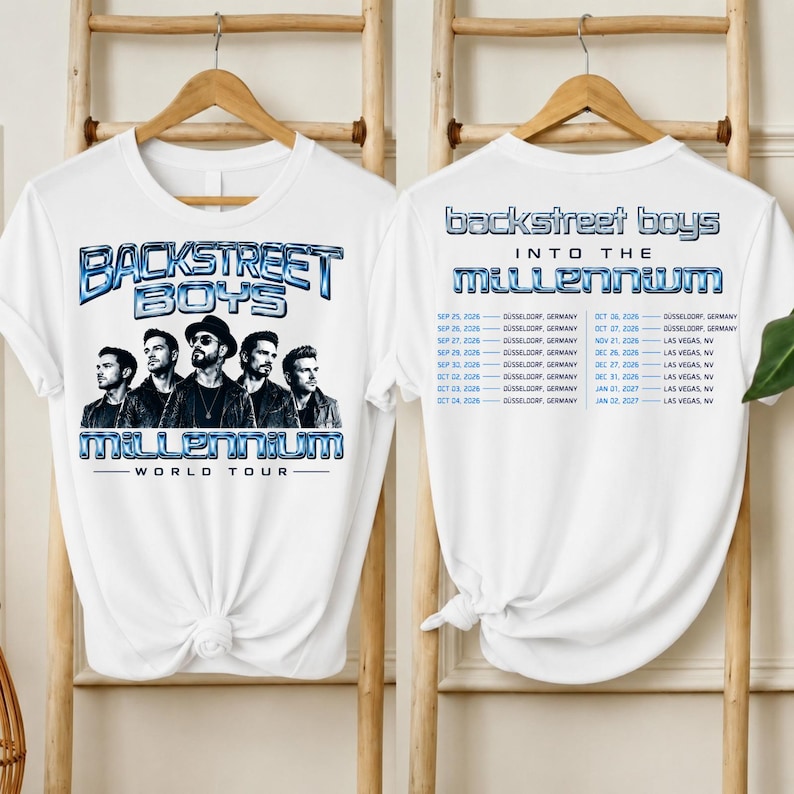 May include: A white t-shirt featuring a graphic of the Backstreet Boys with the text "BACKSTREET BOYS MILLENNIUM WORLD TOUR" on the front. The back displays the text "BACKSTREET BOYS INTO THE MILLENNIUM" and a list of tour dates in Germany and Nevada.