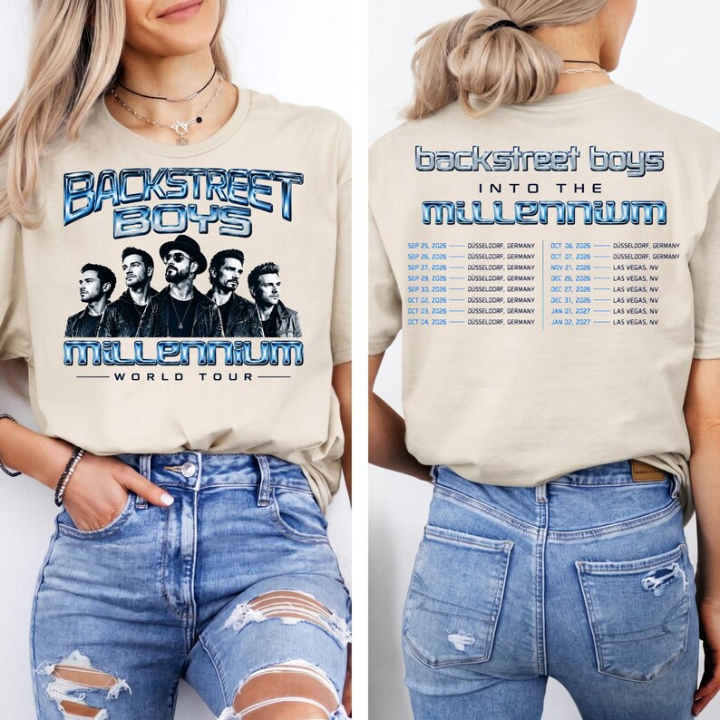 May include: A beige t-shirt featuring a Backstreet Boys Into the Millennium World Tour graphic on the front with a band portrait and metallic blue text. The back displays the tour title and a list of concert dates and locations in blue text.