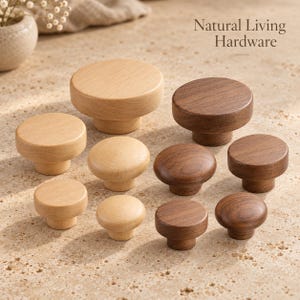 May include: A collection of round wooden cabinet knobs in light and dark brown finishes, arranged in varying sizes. The text Natural Living Hardware is visible in the upper right corner. These knobs feature a smooth, cylindrical base.