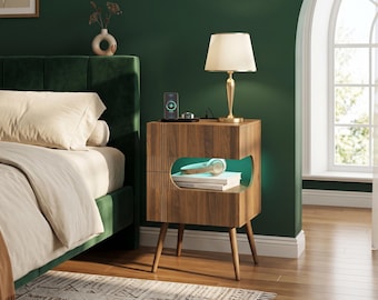 May include: A wooden nightstand with a walnut finish, four tapered legs, and an open storage compartment featuring integrated green LED lighting. The top surface holds a lamp, a smartphone, and a watch, while the shelf contains headphones.