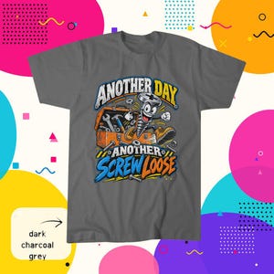 May include: A dark charcoal grey t-shirt featuring a graphic of a cartoon screw character jumping out of an orange toolbox. The text reads "ANOTHER DAY ANOTHER SCREW LOOSE" in bold white, yellow, and blue lettering with various metal hardware scattered.