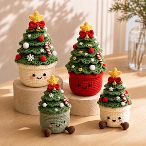 May include: Four crocheted Christmas tree decorations in pots with smiling faces. Each green tree features a yellow star, red bow, small bell, candy cane, and white snowflake accents. The pots are cream, red, and sage green with embroidered eyes.