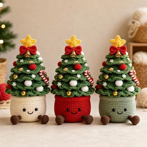 May include: Three crocheted Christmas tree figurines in pots, each topped with a yellow star and red bow with a bell. The trees feature red and white ornaments, candy canes, and white snowflakes. The pots are cream, red, and sage green with faces.