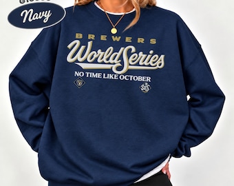 May include: A navy blue crewneck sweatshirt featuring the text G18000 Navy, Brewers World Series, and No Time Like October in white and gold lettering, along with two small baseball-themed logos on the front chest area.
