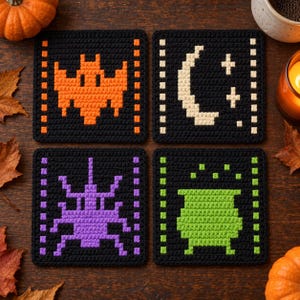 May include: Four square crochet coasters in black with pixelated designs. One features an orange bat, one a white crescent moon and stars, one a purple spider, and one a green cauldron. Each coaster has a vertical border of small colored squares.