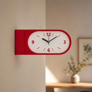 May include: A double-sided wall clock with a red rectangular frame and an oval white face. The clock features red numerals at 3, 6, 9, and 12 o'clock, with red tick marks for the other hours and black hour, minute, and second hands.