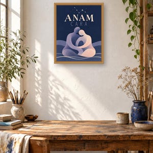 May include: A framed rectangular wall art print featuring a dark blue background with the text ANAM CARA in white capital letters. Below the text, two stylized figures in shades of purple and light pink are shown embracing in a seated position.