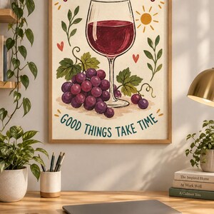May include: A rectangular wall art print in a wooden frame featuring a glass of red wine, a cluster of purple grapes, green leaves, a yellow sun, and small red hearts. The text reads SIP THE SWEET MOMENTS at the top and GOOD THINGS TAKE TIME at the bottom.