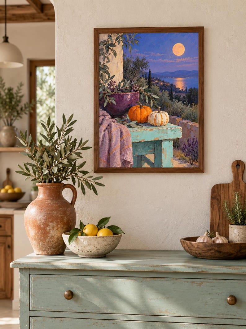 May include: A framed wall art print depicting a moonlit coastal landscape with a turquoise table holding a purple bowl, an orange pumpkin, and a white striped pumpkin, draped with a lavender cloth, all set against a backdrop of trees and water.
