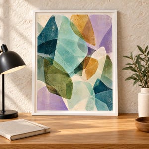 May include: A framed wall art print featuring an abstract composition of overlapping organic shapes in shades of teal, olive green, mustard yellow, and soft lavender, set against a light cream background with a textured, layered appearance.
