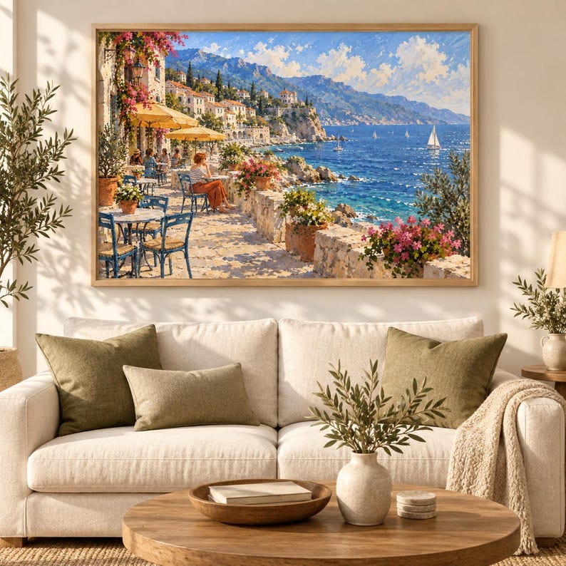 May include: A rectangular wall art print featuring a coastal Mediterranean scene with a seaside terrace, blue chairs, yellow umbrellas, and potted pink flowers overlooking a deep blue sea with sailboats under a bright sky with white clouds.