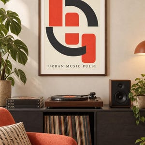 May include: A framed wall art print featuring a cream background with bold red and black geometric shapes and the text URBAN MUSIC PULSE centered at the bottom. The design consists of two vertical red rectangles and two black curved arcs.