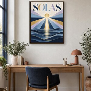 May include: A framed rectangular wall art print featuring the word SOLAS in bold lettering at the top. The artwork depicts a stylized sun rising over dark blue ocean waves with radiating beams of light in shades of gold, blue, and lavender.