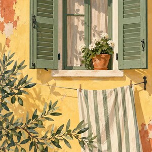 May include: A yellow wall features a window with open sage green shutters and a terracotta pot containing white flowers. A striped green and white cloth hangs on a line below the window, next to an olive tree branch with green olives.