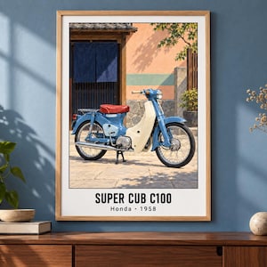 May include: A framed wall print featuring a blue Honda Super Cub C100 motorcycle with a red seat and cream-colored leg shield, parked in front of a building with a blue curtain. The text SUPER CUB C100 Honda 1958 is printed at the bottom.
