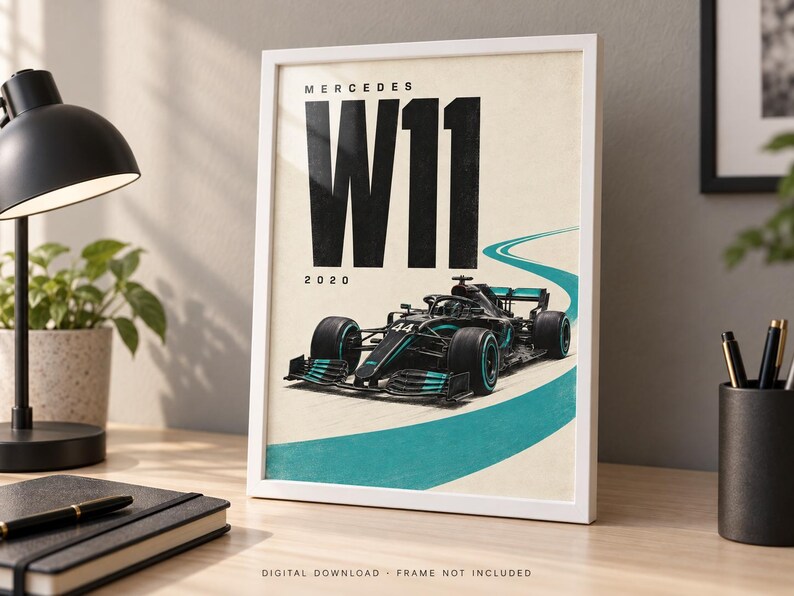 May include: A framed poster featuring a black Mercedes W11 Formula 1 race car with teal accents on a cream background. The text reads MERCEDES W11 2020 in bold black letters. A teal curved line represents a track, and the car displays the number 44.
