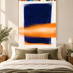 K&ouml;nnte beinhalten: Ein rechteckiger Wandkunstdruck mit einem gro&szlig;en, vertikalen, tiefblauen Block auf wei&szlig;em Hintergrund. Ein horizontaler, leuchtend orangefarbener Pinselstrich &uuml;berlagert den blauen Bereich, akzentuiert durch feine, wei&szlig;e, handgezeichnete Linien.