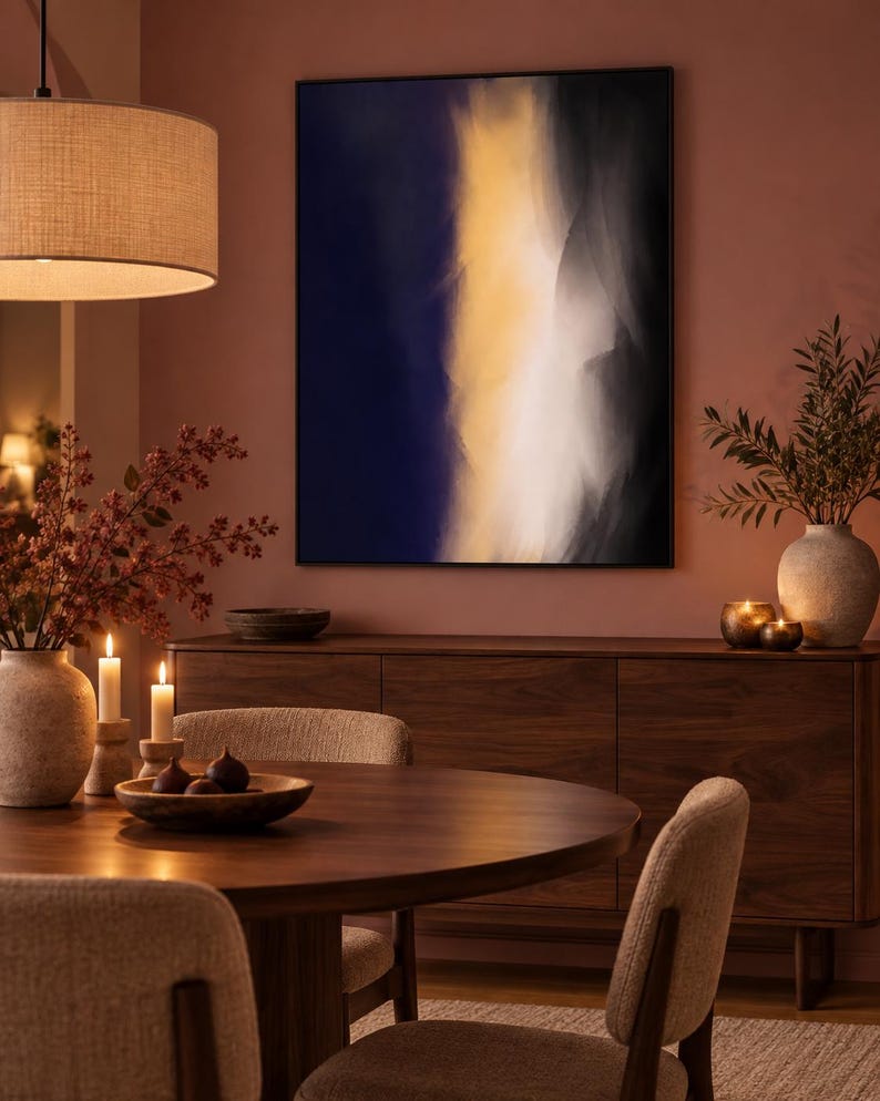 May include: A rectangular wall art piece featuring an abstract composition with a vertical band of bright yellow light transitioning into deep navy blue and black shadows, framed in a thin black border and mounted on a muted terracotta wall.