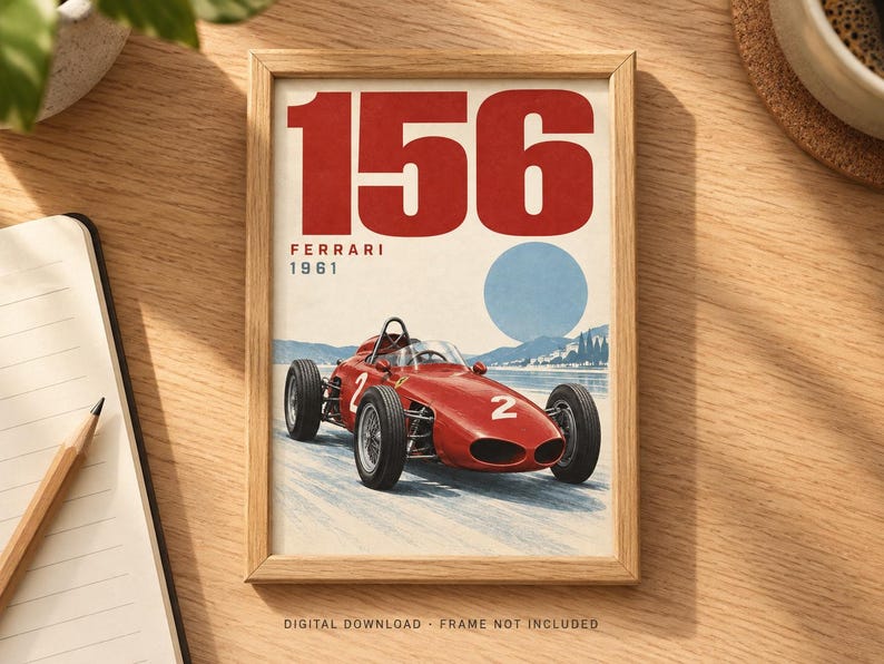 May include: A framed print featuring a red 1961 Ferrari 156 race car with the number 2 on its side. The artwork displays the text 156, FERRARI, and 1961 above the car, set against a light background with a blue circle representing the sun.