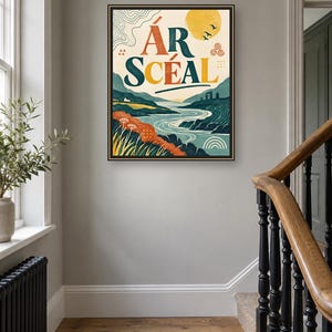 May include: A framed rectangular wall art print featuring a landscape illustration with a river, rolling hills, and a yellow sun. The text &Aacute;R SC&Eacute;AL is printed in large, bold letters at the top. The color palette includes shades of blue, green, orange, and yellow.