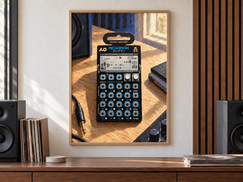 May include: A black Teenage Engineering PO-128 Mega Man pocket operator synthesizer featuring a digital LCD screen, sixteen circular buttons, two silver knobs, and the text "MEGAMAN" printed in blue above the display on a wooden surface.