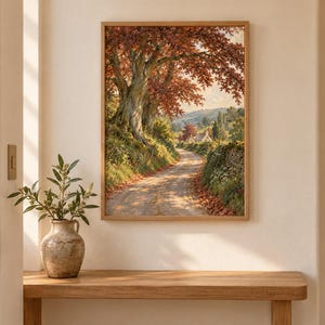 Puede incluir: Una impresi&oacute;n de arte mural rectangular enmarcada que presenta una pintura de paisaje de un camino de tierra que serpentea a trav&eacute;s de una escena rural con grandes &aacute;rboles con follaje oto&ntilde;al en tonos naranja y marr&oacute;n, hierba verde y un muro de piedra.