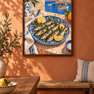 May include: A framed wall art print depicting a Mediterranean coastal scene with a blue and white patterned plate holding grilled fish garnished with parsley and lemon wedges, set against a backdrop of a harbour with boats and white buildings.