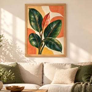 May include: A framed wall art print featuring a rubber plant with large, glossy dark green leaves and a single vibrant red leaf at the center. The background consists of abstract, soft-edged shapes in shades of orange and yellow, all enclosed in a light-colored wooden frame.