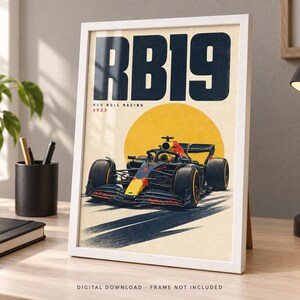 May include: A framed poster featuring a dark blue and red Formula 1 race car centered below a large yellow circle. The text RB19 is printed in large dark blue letters at the top, with Red Bull Racing 2023 written in smaller text below it.