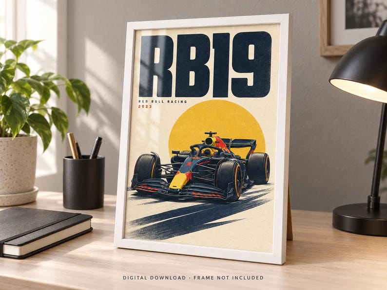 May include: A framed poster featuring a dark blue and red Formula 1 race car centered below a large yellow circle. The text RB19 is printed in large dark blue letters at the top, with Red Bull Racing 2023 written in smaller text below it.