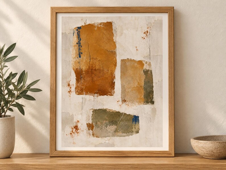 May include: A framed abstract wall art print featuring three distinct rectangular shapes in shades of ochre, burnt orange, and muted olive green against a textured off-white background with subtle blue and rust-coloured paint splatters.