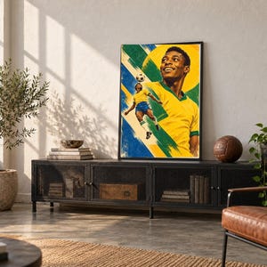 May include: A framed vertical poster featuring a stylized illustration of a soccer player in a yellow and green jersey. The artwork depicts the player in a dynamic pose with a soccer ball, set against a vibrant yellow and blue background.