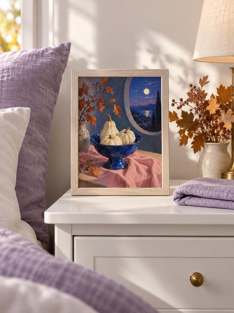 May include: A framed painting depicting a blue pedestal bowl filled with three white pumpkins, set on a pink cloth. Beside the bowl is a vase with autumn leaves. The background shows a circular window view of a moonlit landscape at night.