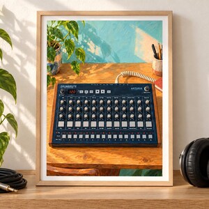 Puede incluir: Una impresi&oacute;n enmarcada de una caja de ritmos anal&oacute;gica Arturia DrumBrute con panel de control azul oscuro, perillas plateadas y paneles laterales de madera. El dispositivo muestra el texto DrumBrute y Arturia, con una pantalla digital.