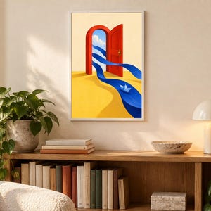 May include: A framed wall art print featuring a surreal illustration of a bright red door standing on a yellow surface. A blue ribbon-like stream flows from the open door across the yellow ground, carrying a small blue paper boat toward the viewer.