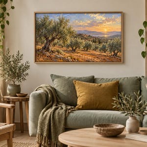 May include: A rectangular landscape painting in a light wood frame depicting an olive grove at sunset. The scene features gnarled olive trees with silvery-green leaves, golden-brown earth, and a distant view of hills and water under a warm sky.