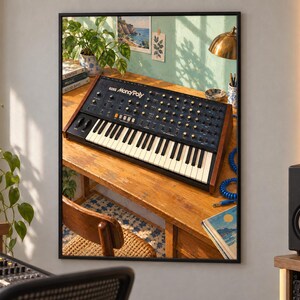 May include: A Korg Mono/Poly analog synthesizer featuring a black control panel with numerous knobs, switches, and a keyboard with white and black keys, housed in a wooden frame, positioned on a wooden desk surface in a studio environment.