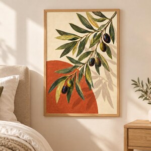 May include: A framed wall art print featuring a painted olive branch with green leaves and dark olives hanging over a large, solid terracotta-colored circle against a cream-colored background, enclosed in a light-toned wooden frame.