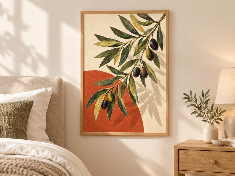 May include: A framed wall art print featuring a painted olive branch with green leaves and dark olives hanging over a large, solid terracotta-colored circle against a cream-colored background, enclosed in a light-toned wooden frame.