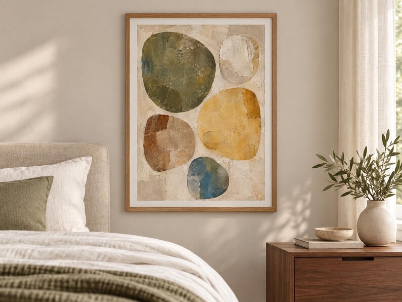 May include: A framed wall art print featuring an abstract composition of five large, rounded organic shapes in shades of olive green, mustard yellow, terracotta brown, muted blue, and off-white, set against a textured, neutral-toned background.