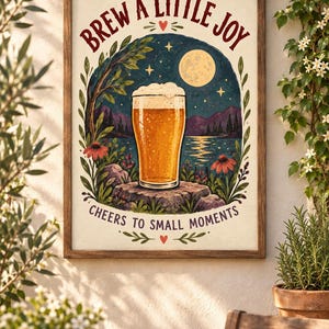 May include: A framed wall art print featuring a glass of golden beer on a tree stump, set against a night landscape with a full moon, mountains, and a lake. The text reads BREW A LITTLE JOY and CHEERS TO SMALL MOMENTS with small heart icons.