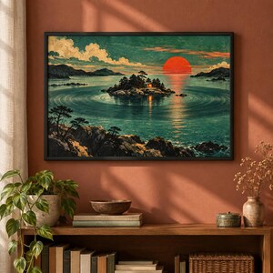 May include: A rectangular wall art print featuring a landscape painting of a small island with a cabin surrounded by calm water, circular ripples, and a large red sun on the horizon. The scene includes dark rocky shores, pine trees, and clouds.