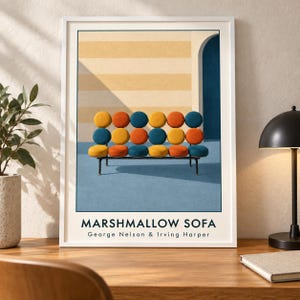 May include: A framed art print featuring a Marshmallow Sofa by George Nelson & Irving Harper. The illustration depicts a sofa with circular cushions in yellow, orange, and blue, set against a striped wall and a blue floor with an arched doorway.