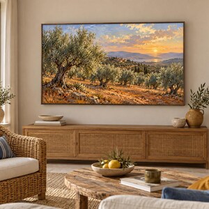 May include: A rectangular wall-mounted television displaying a landscape painting of an olive grove at sunset with golden light, rolling hills, and a distant body of water, positioned above a long wooden media console with cane paneling.